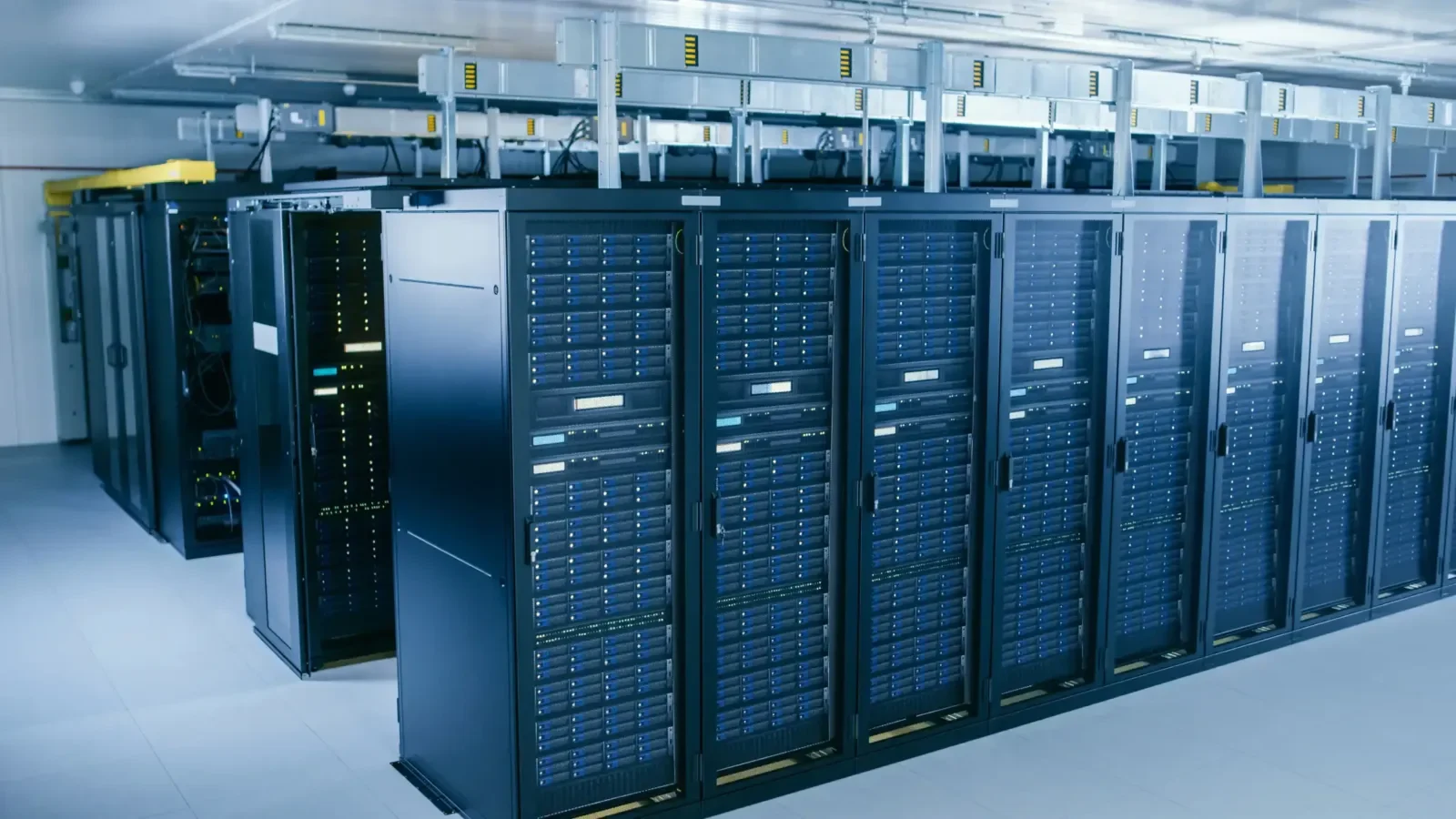 An aisle of server racks in the clean room of a data center